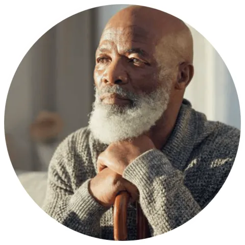 Older man in room thinking