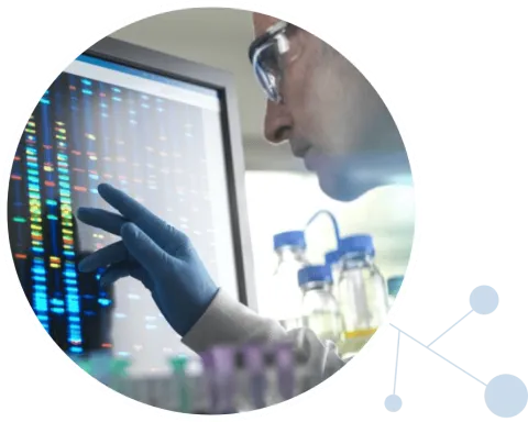 Scientist looking at monitor with DNA data on it